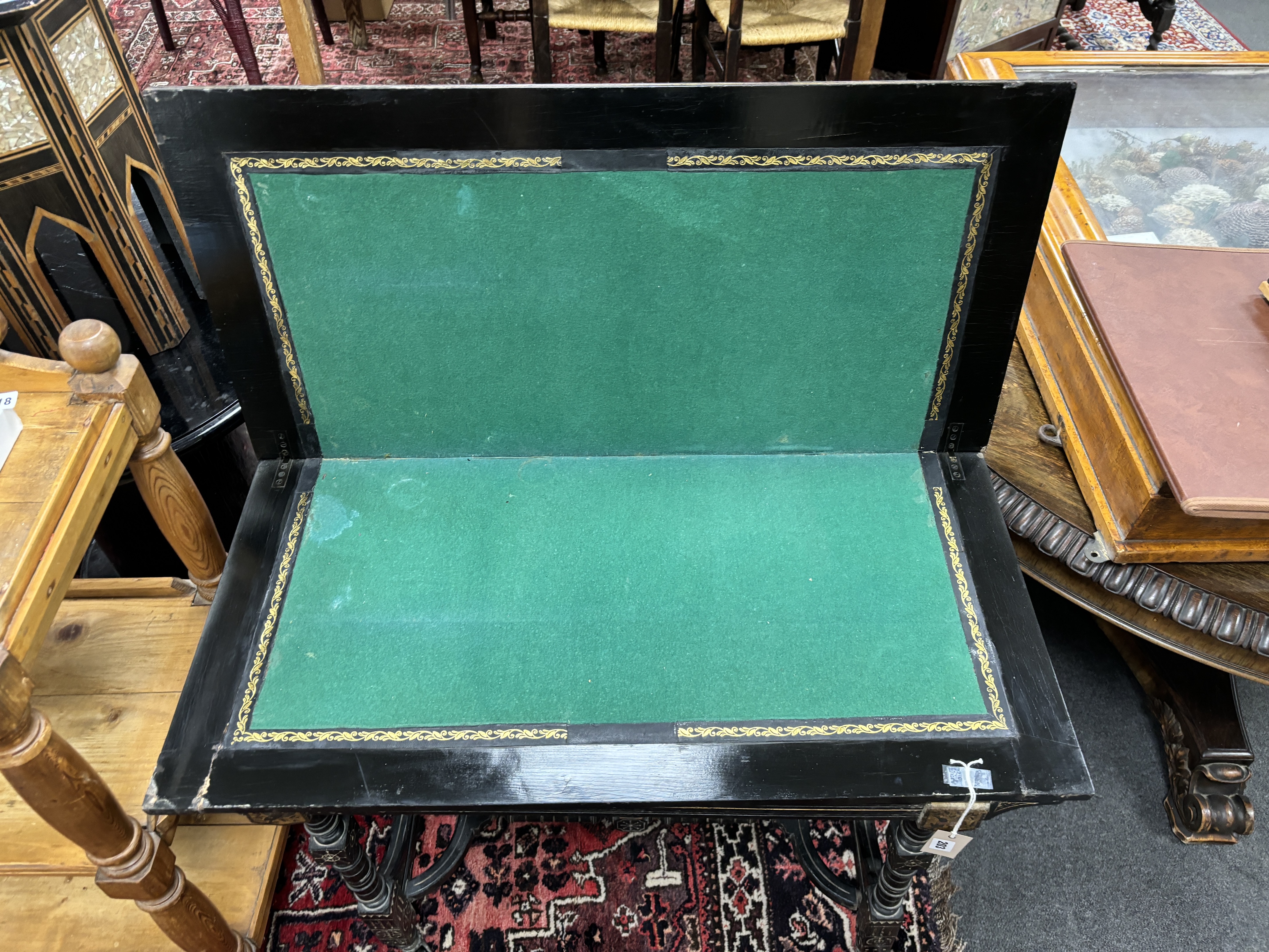 A late Victorian aesthetic movement ebonised folding card table, width 92cm, depth 44cm, height 76cm